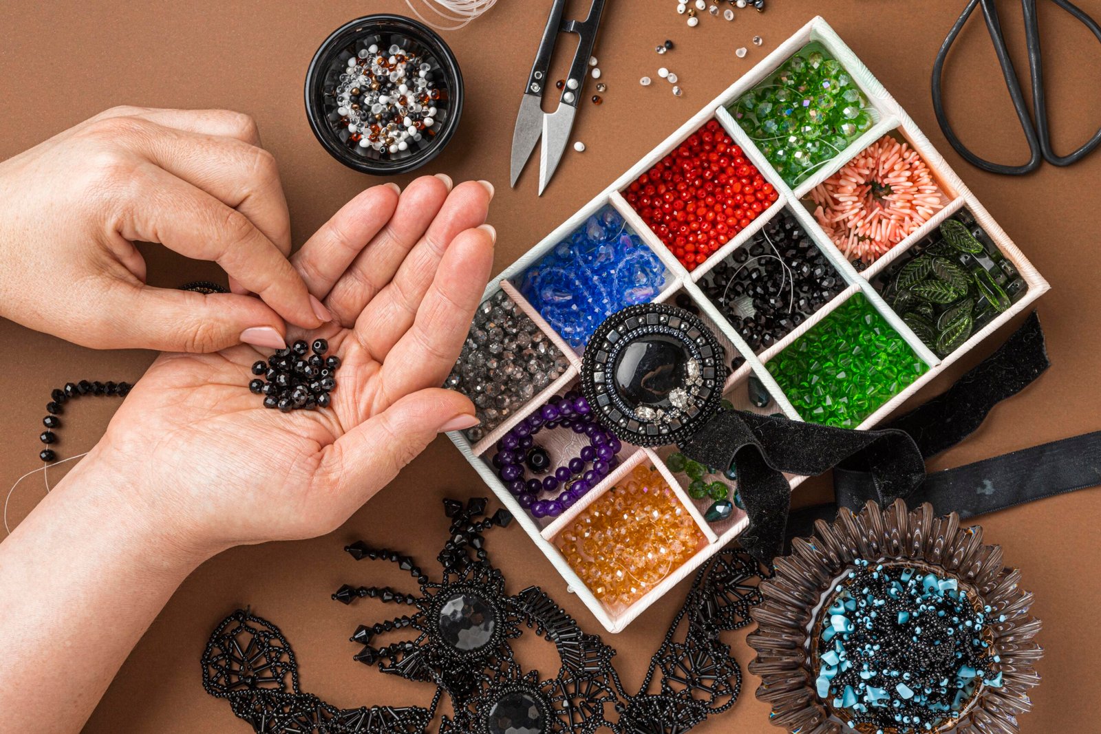 Flat lay person doing bead work scaled